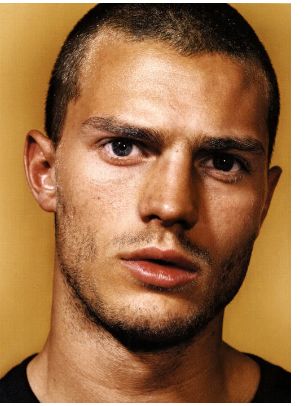 image of Jamie Dornan bald head looking very cute
